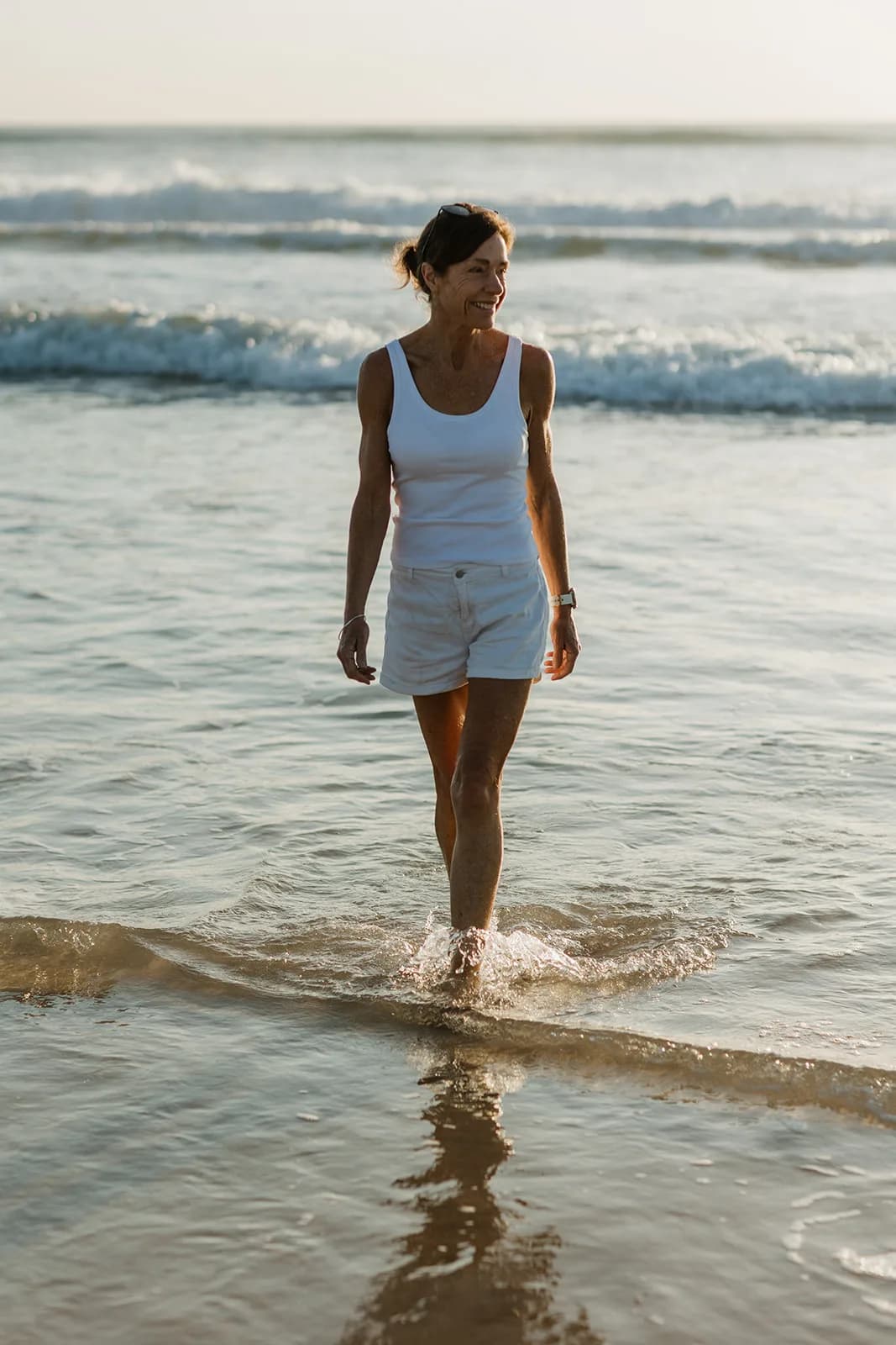 Dana Eden walking out of the surf toward the camera