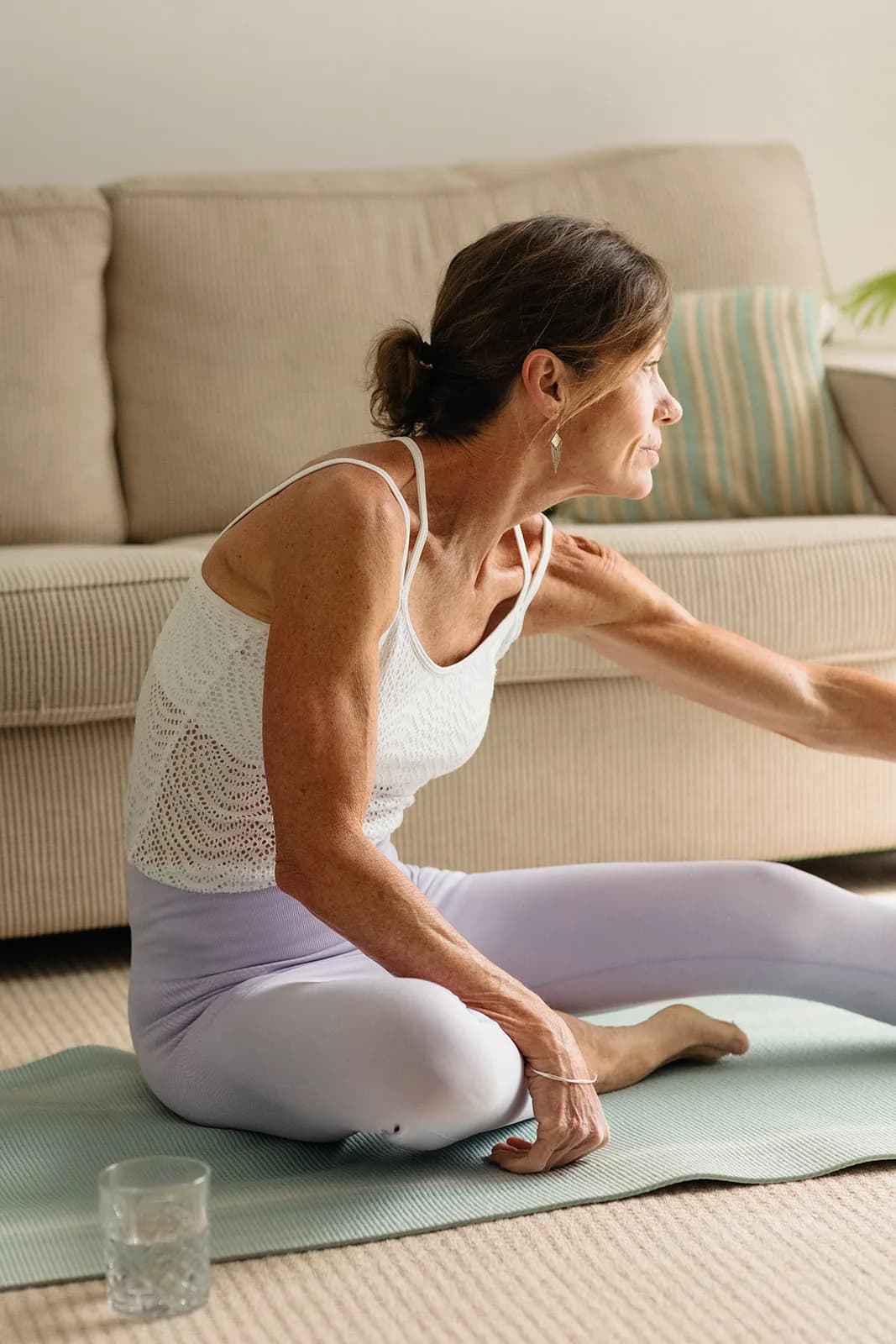 Dana Eden stretching on a mat at home